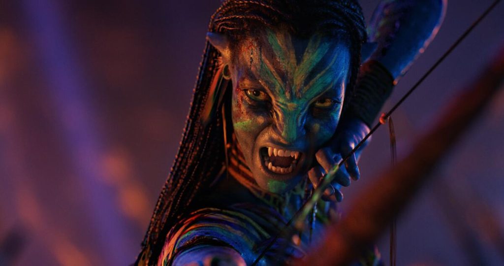 Fierce Na’vi warrior aiming a bow with glowing war paint in a battle stance.