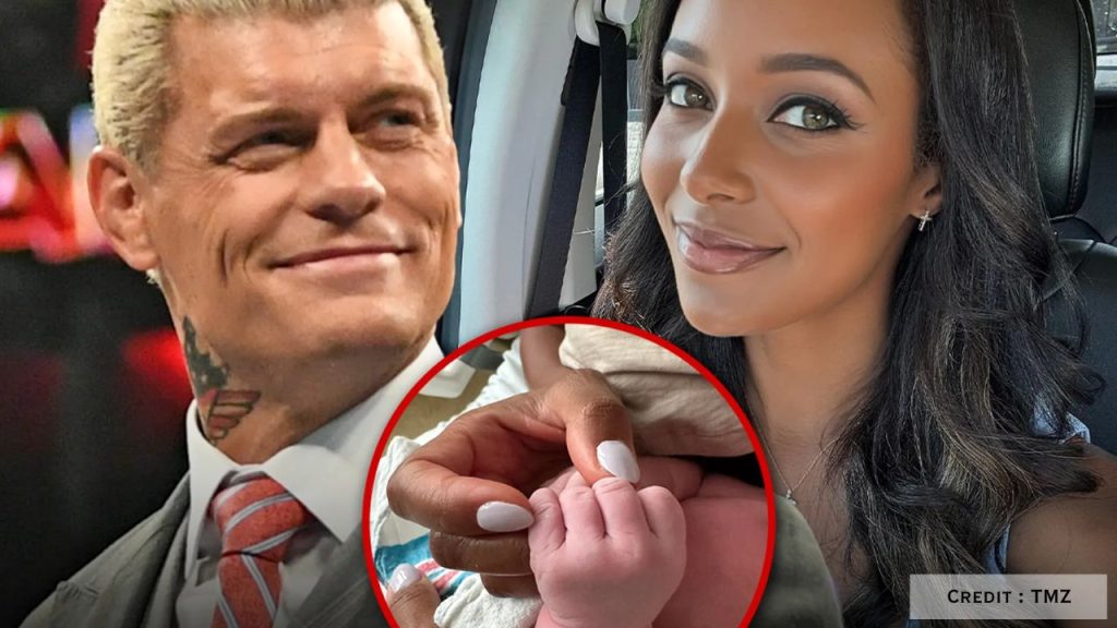 Brandi Rhodes holding newborn Leilani’s hand beside Cody Rhodes in hospital reveal photo.