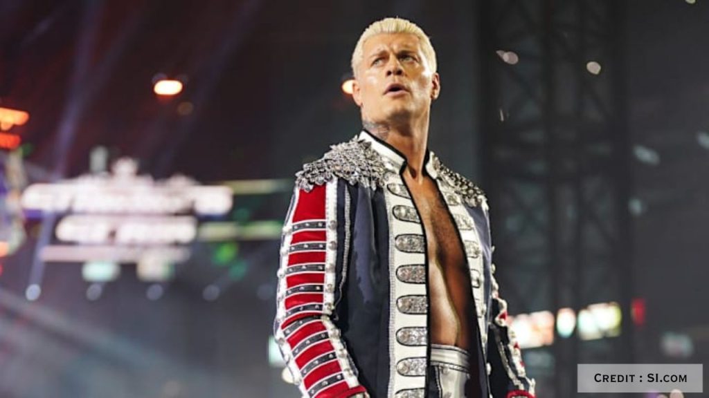 WWE star Cody Rhodes raising his title belt, symbolizing his ring life amid joyous family news.