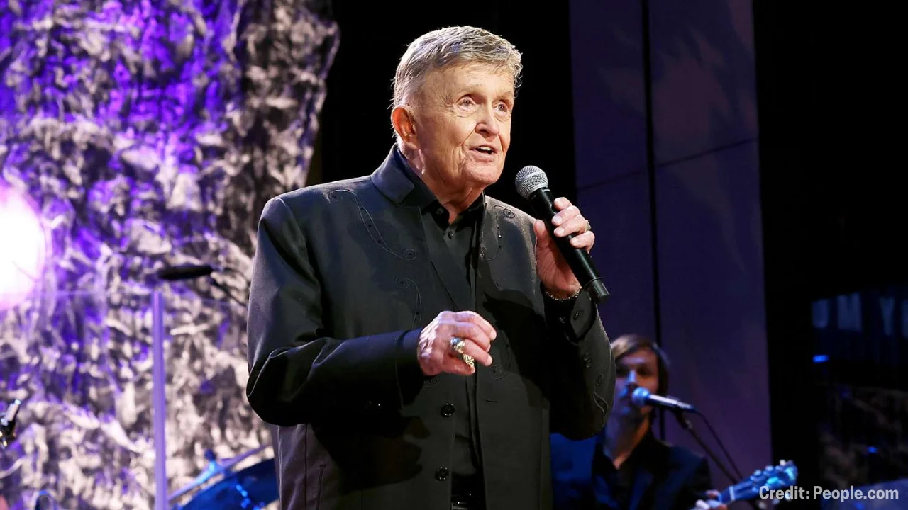 Bill Anderson speaking onstage at a recent event