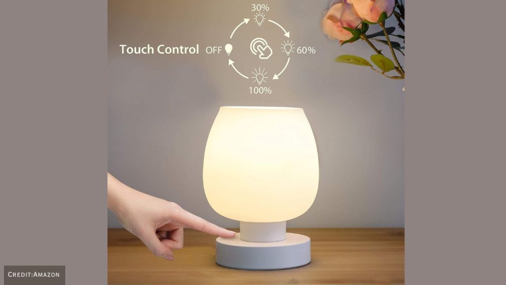 Stylish dimmable touch bedside lamp with warm lighting for a modern living room.