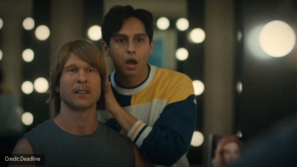 Glen Powell fully in character as Chad Powers on set, wearing a football-themed disguise.
Source: