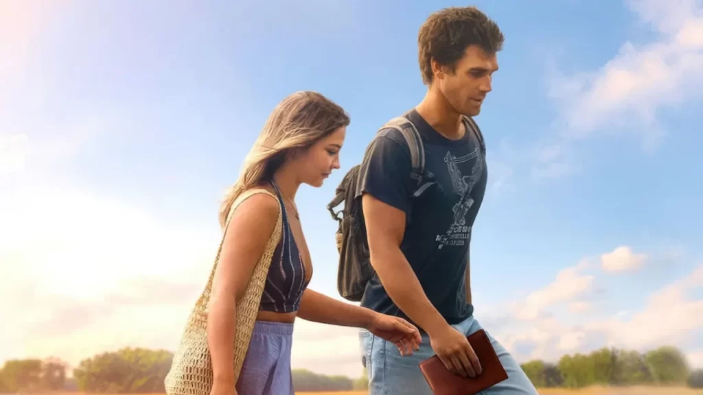 Madelyn Cline and KJ Apa walking together through scenic European fields in the film