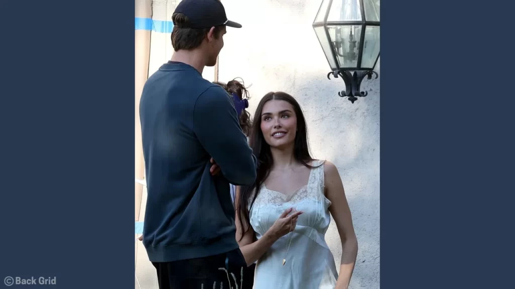 Candid photo of Madison Beer and Justin Herbert interacting casually on set in August 2025.