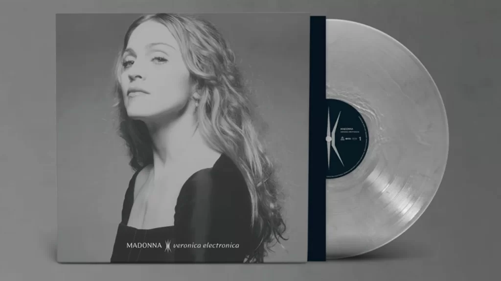 Sleek silver promotional art for Madonna’s Veronica Electronica, highlighting the futuristic electronic theme.