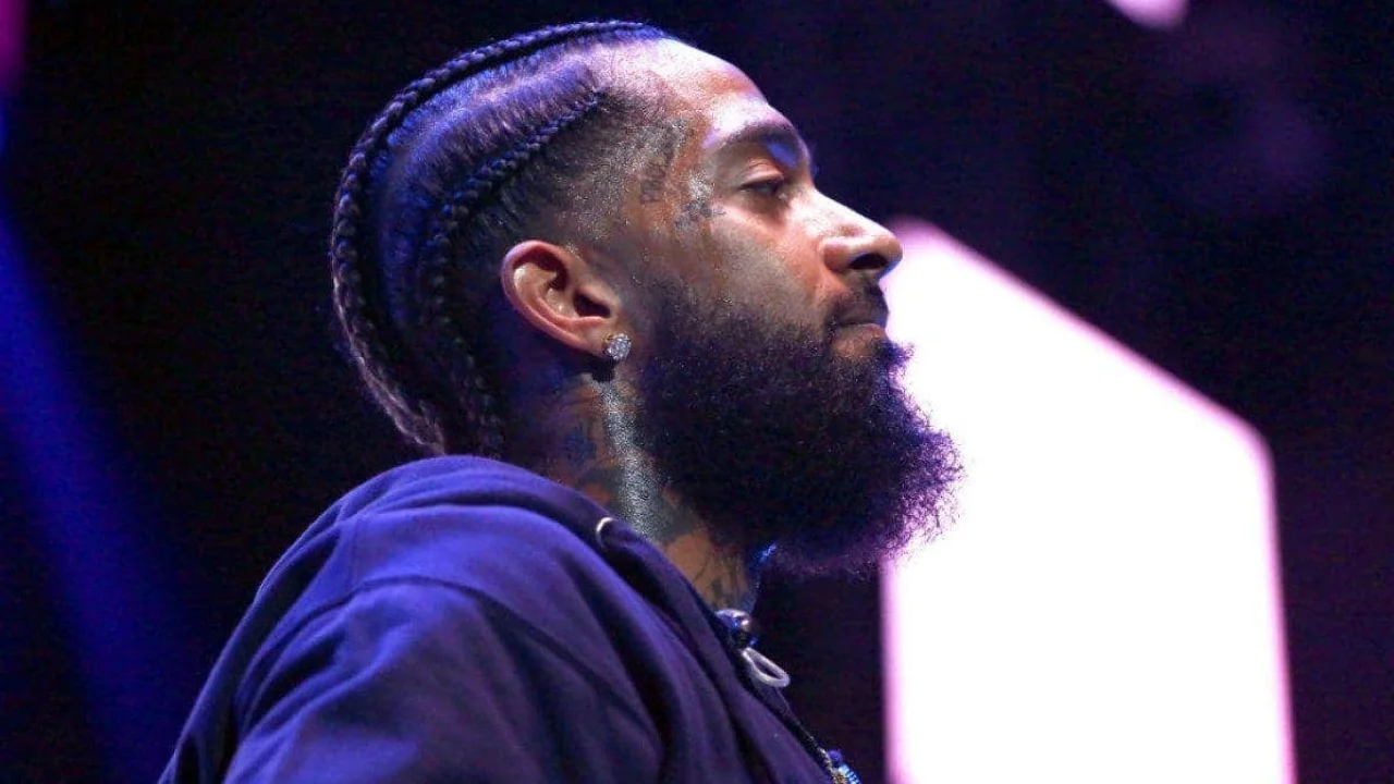 Respectful portrait of Nipsey Hussle displayed during a public tribute, symbolizing his cultural and community impact.