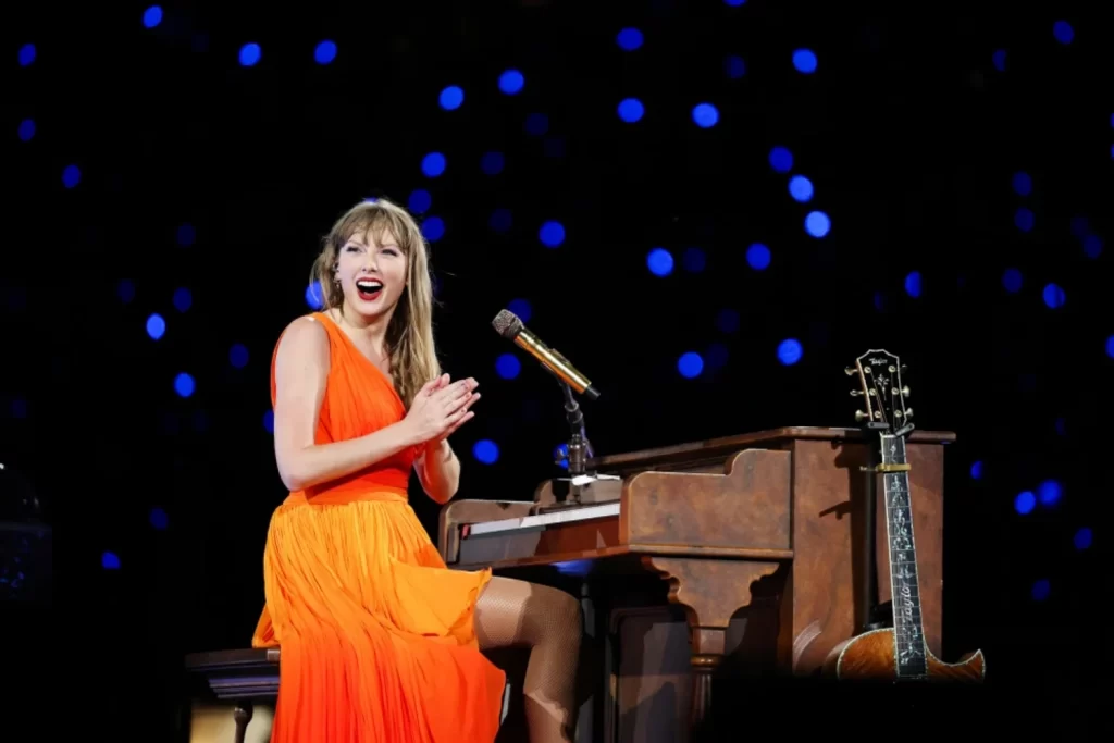 Taylor Swift holding a briefcase revealing The Life of a Showgirl album on New Heights podcast.