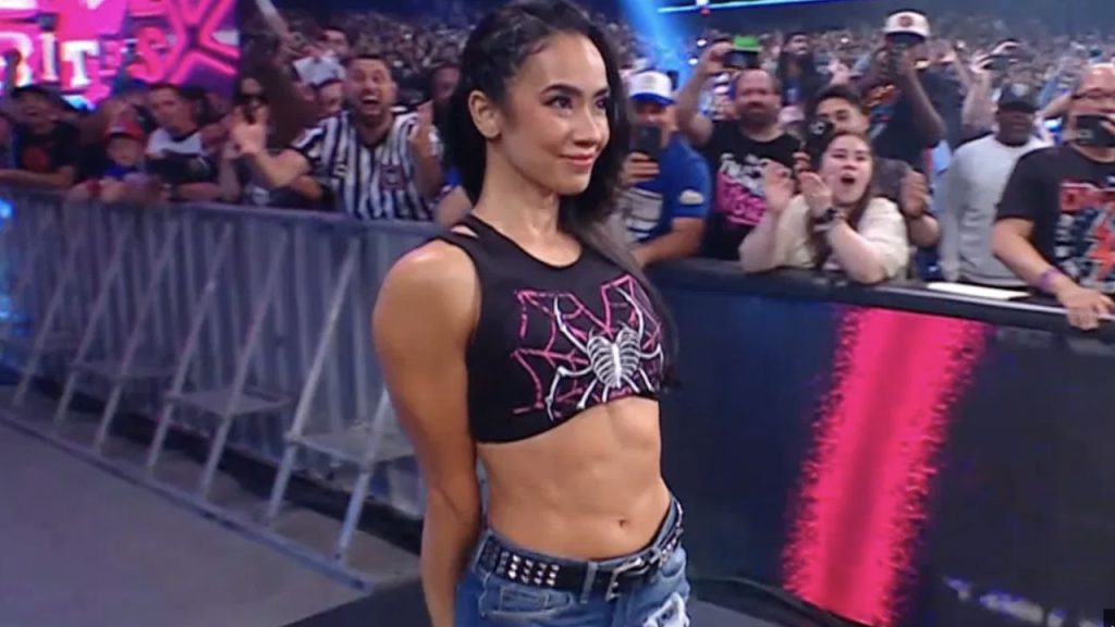 AJ Lee posing in the ring as fans cheer her epic WWE comeback