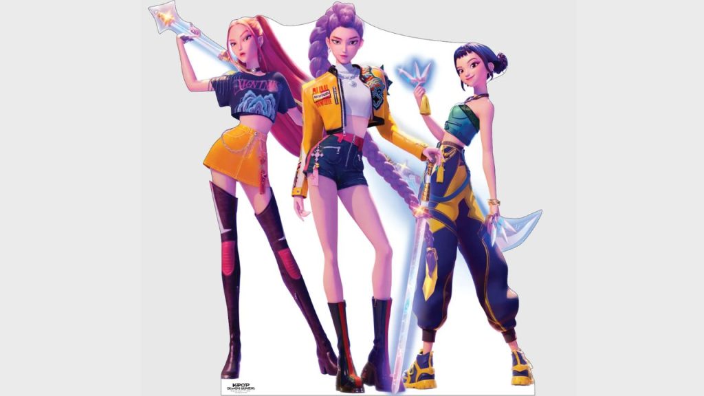 Life-size HUNTR/X cutout standee showing the group’s three members in dynamic, colorful outfits.