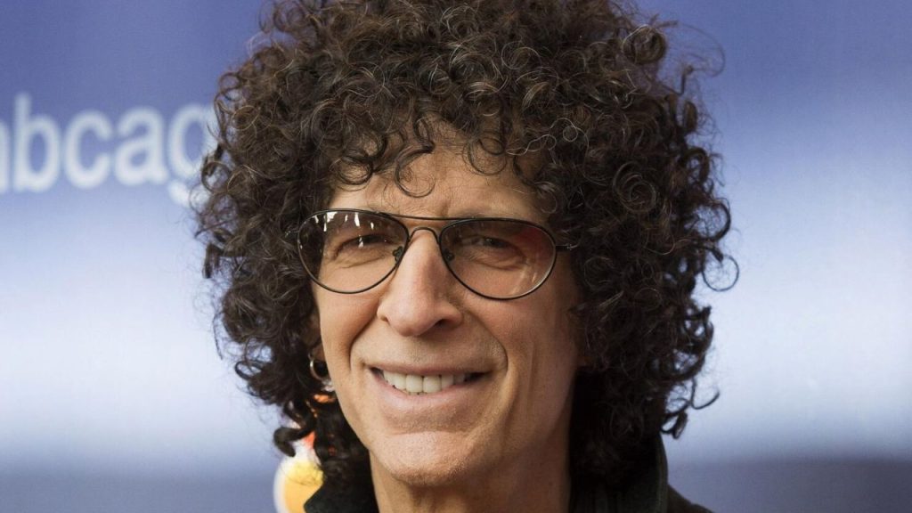 Close-up of Howard Stern smiling at a public event in earlier years, highlighting his iconic persona and media longevity.