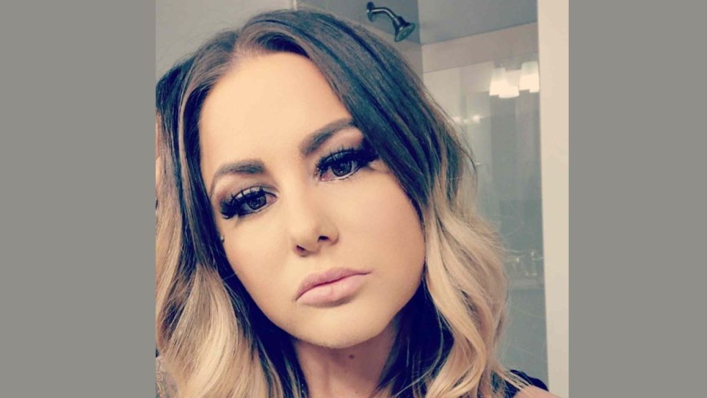 Kelsey Bateman appearing thoughtful in a bathroom selfie